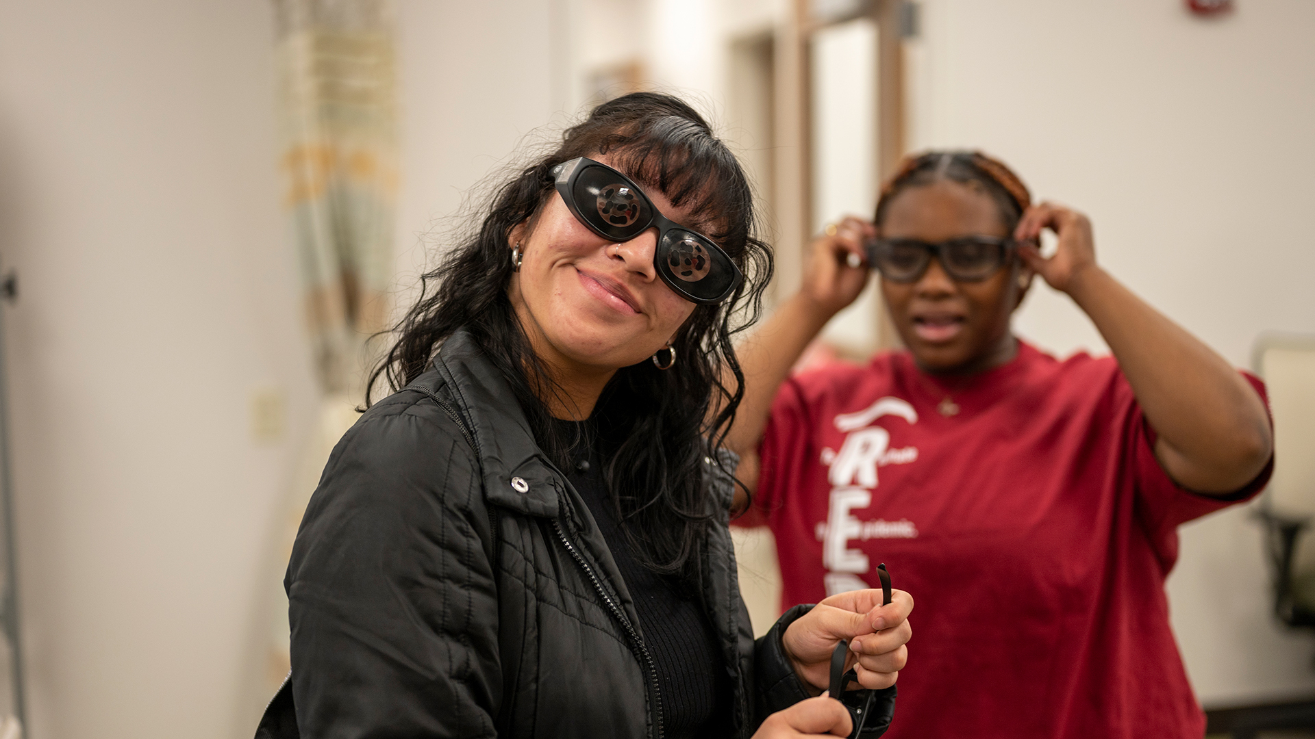 Female high school students wearing goggles in a nursing lab