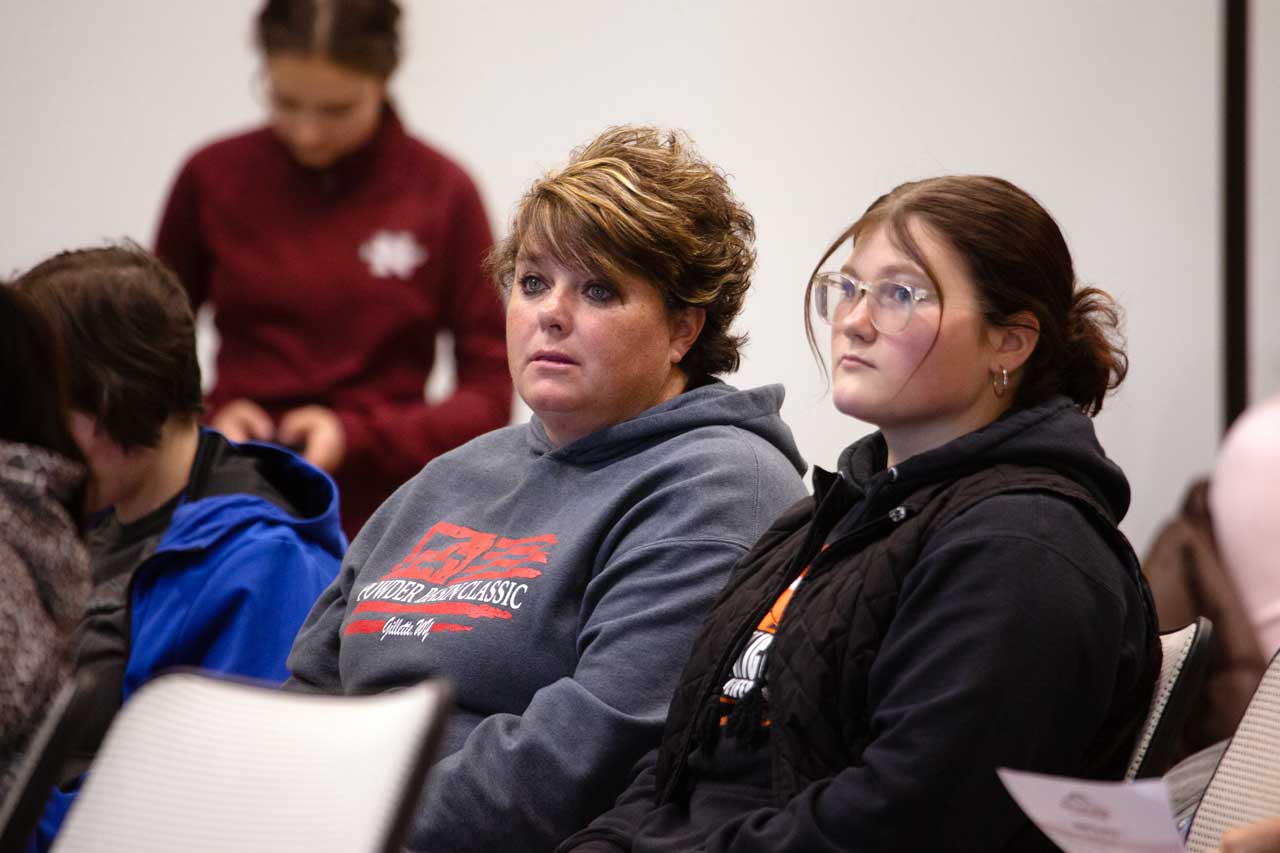 Female high school students wearing goggles in a nursing lab