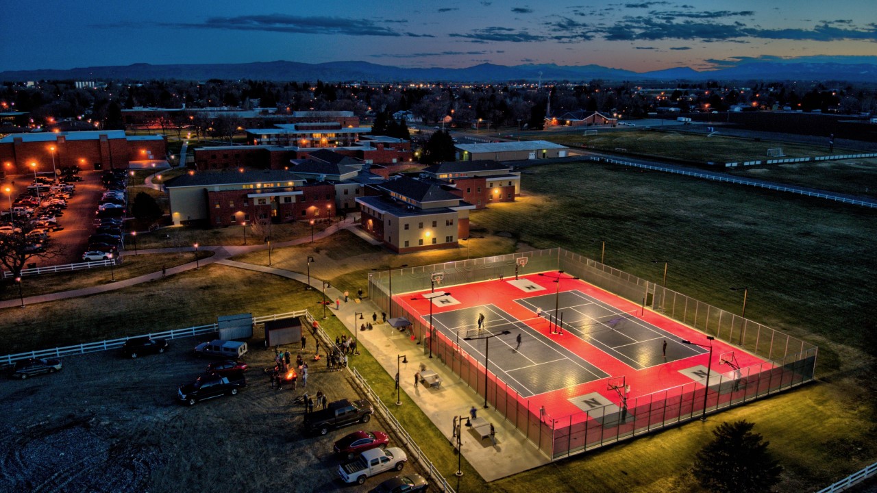 Campus aerial looking west with sunset behind mountains