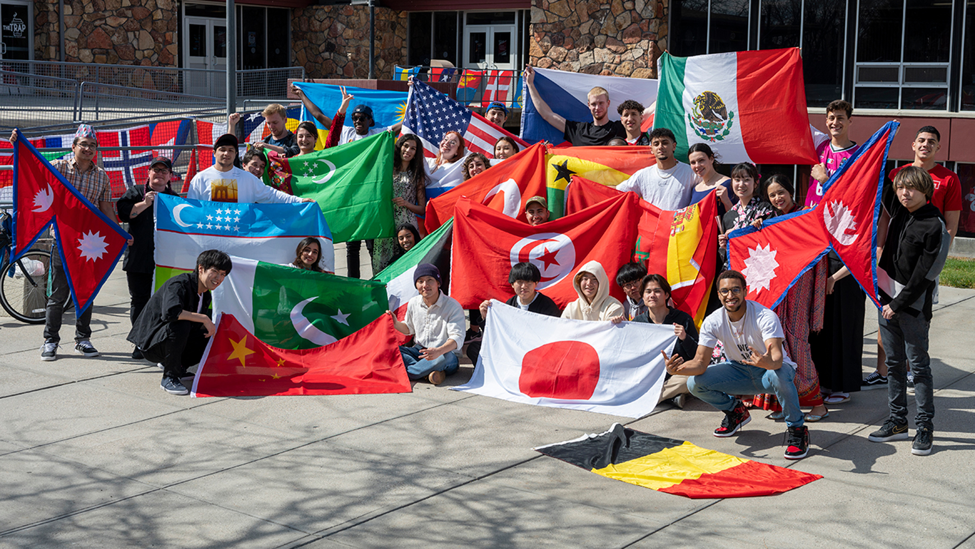 Students holding various countries' flags