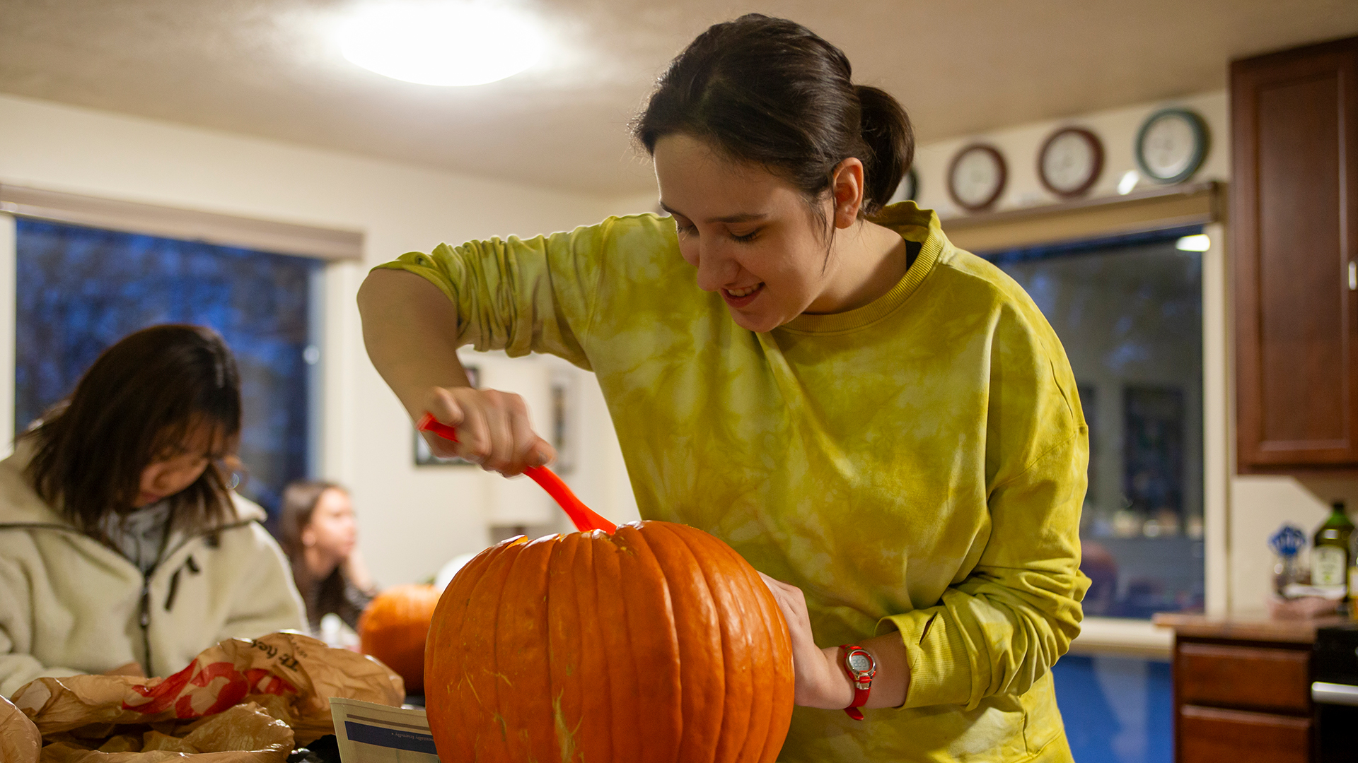 Female student preparing to carve a pumpkin