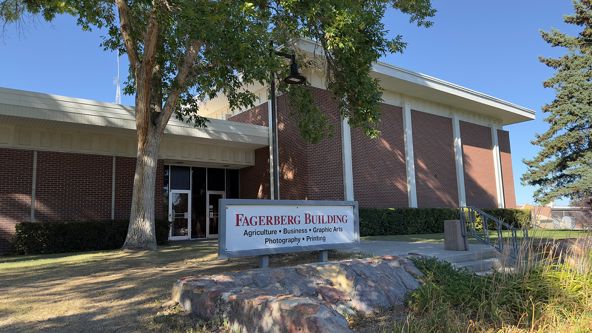 Outside front entrance of Fagerberg Building on a sunny fall afternoon